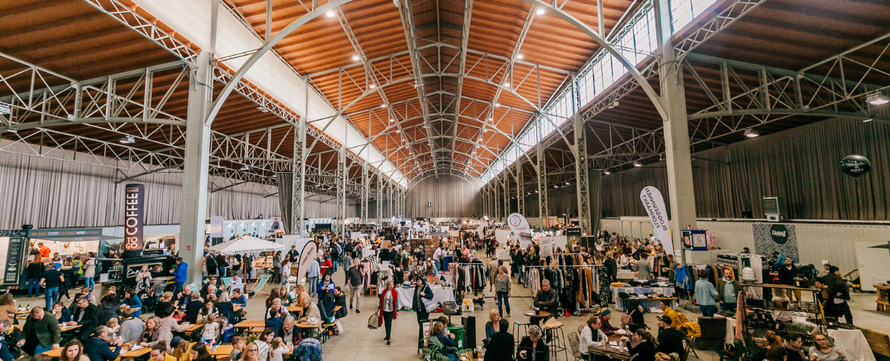 Marx Halle mit vielen Menschen auf dem Edelstoffmarkt, Verkaufsstände